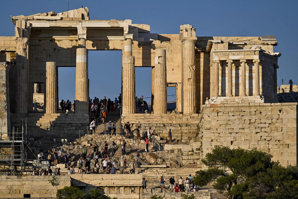 Tourists on the propylaea of the Acropolis in Athens in June 2023.