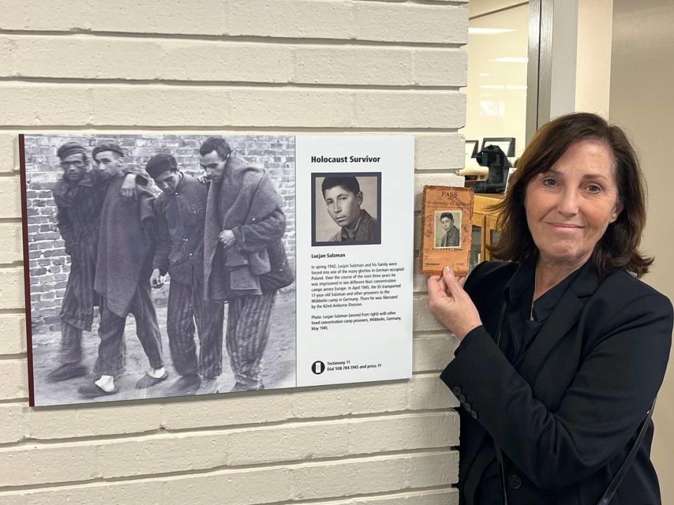 Anna Salton Eisen, right, holds the original picture of the pass her father received after he was liberated from a concentration camp in Germany. Eisen visited the Fort Worth History Center on Feb. 9 to see her father in the“American Witnesses” exhibit. Anna Salton Eisen