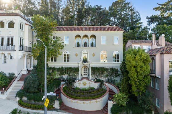 Perched at the eastern edge of the Presidio Wall, at the intersection of Pacific Heights and Cow Hollow, the 1920s home enjoys enchanting Bay and City views to the north and east.