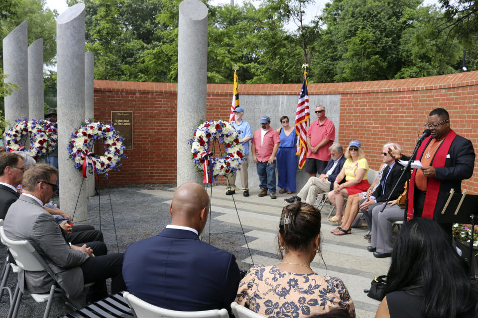 The Rev. John Crestwell , right, speaks during a wreath-laying ceremony at the Guardians of the First Amendment Memorial, Wednesday, June 28, 2023 in Annapolis, Md., on the fifth anniversary of the shooting at the Capital Gazette newsroom that killed five people in 2018. (AP Photo/Brian Witte)