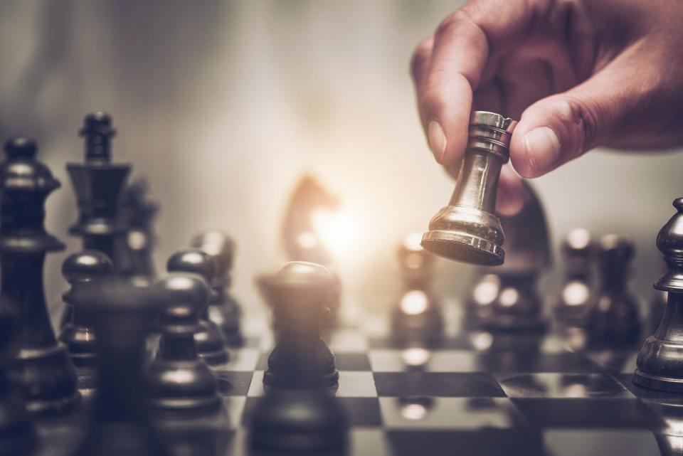 Hand moves chess piece during a game