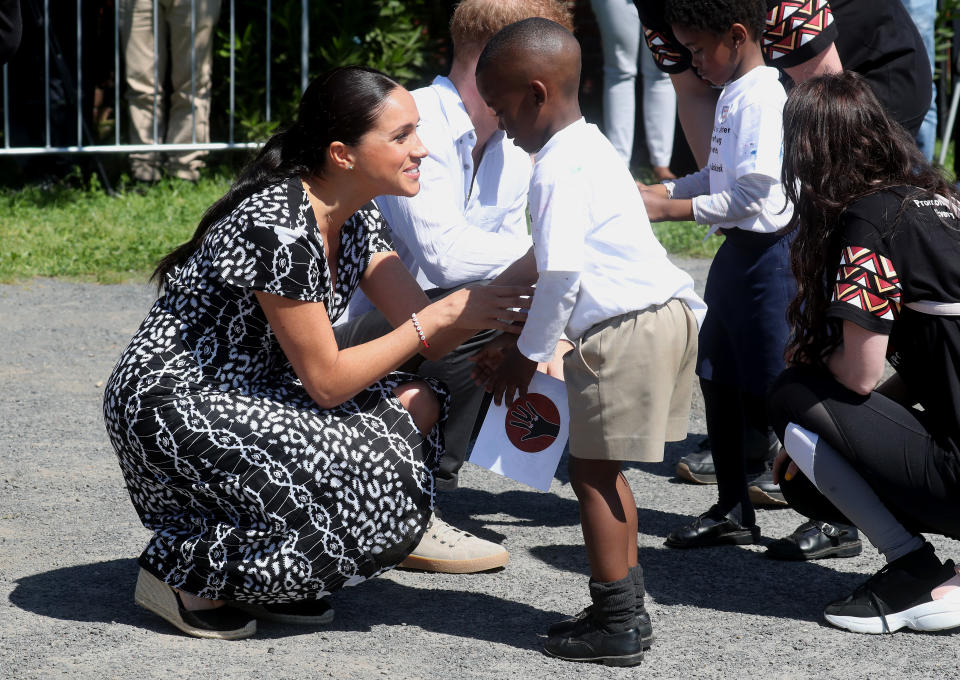 CAPE TOWN, SOUTH AFRICA - SEPTEMBER 23: Meghan, Duchess of Sussex and Prince Harry, Duke of Sussex meet young wellwishers as they visit a Justice Desk initiative in Nyanga township, during their royal tour of South Africa on September 23, 2019 in Cape Town, South Africa. The Justice Desk initiative teaches children about their rights and provides self-defence classes and female empowerment training to young girls in the community. (Photo by Chris Jackson/Getty Images)