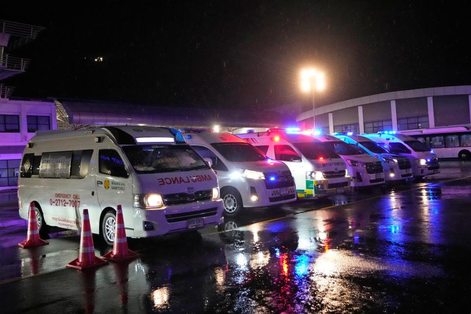 Ambulances wait to carry passengers from a London-Singapore flight that encountered severe turbulence, in Bangkok, Thailand, Tuesday, May 21, 2024.