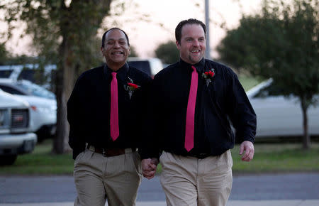 FILE PHOTO: Darren Black Bear (L) and Jason Pickel arrive to be married by Darren's father Rev. Floyd Black Bear in El Reno, Oklahoma October 31, 2013. REUTERS/Rick Wilking/File Photo