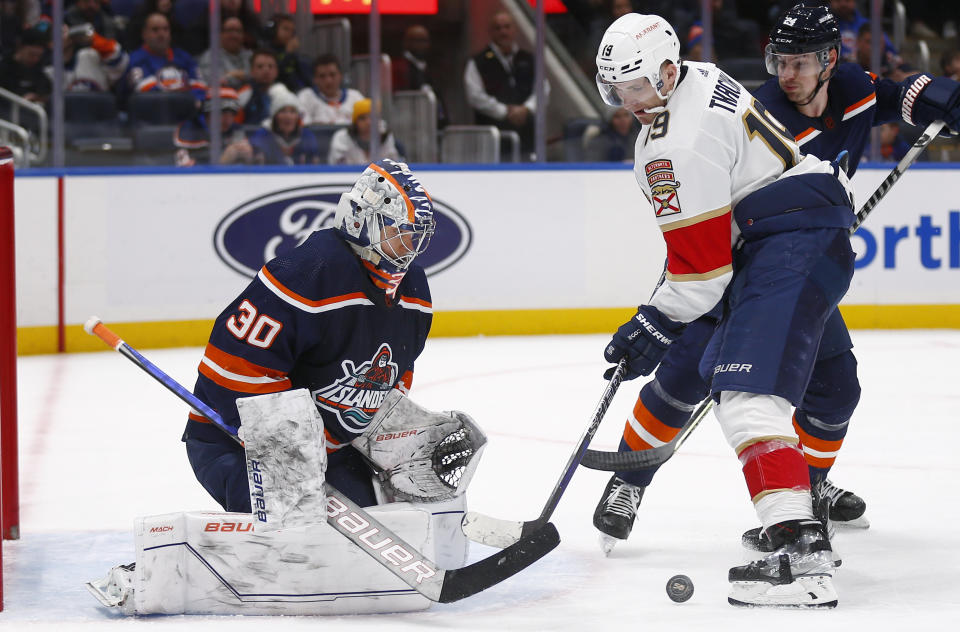 New York Islanders goalie Ilya Sorokiin (30) makes a save in front of Florida Panthers forward Matthew Tkachuk (19) during the third period of an NHL hockey game Friday, Dec. 23, 2022, in Elmont, N.Y. The Islanders won 5-1. (AP Photo/John Munson)