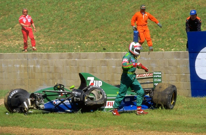 Andrea de Cesaris of Italy walks away from his Jordan Ford during the 1991 British Grand Prix at the Silverstone circuit in England.