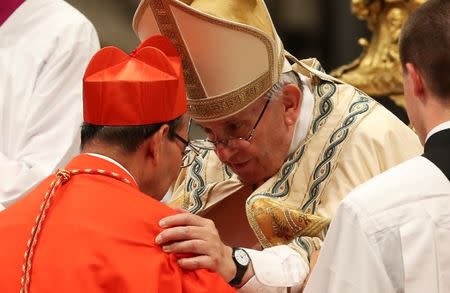 Pope Francis greets Cardinal Gregorio Rosa Chavez (L) during a consistory as he elevate five Roman Catholic prelates to the rank of cardinal, at Saint Peter's Basilica at the Vatican, June 28, 2017. REUTERS/Alessandro Bianchi