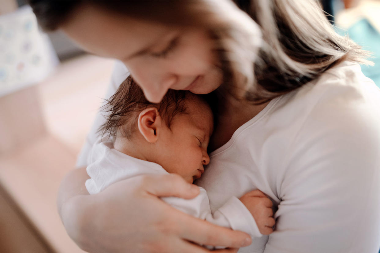 Mother holding a newborn baby Getty Images/Halfpoint Images