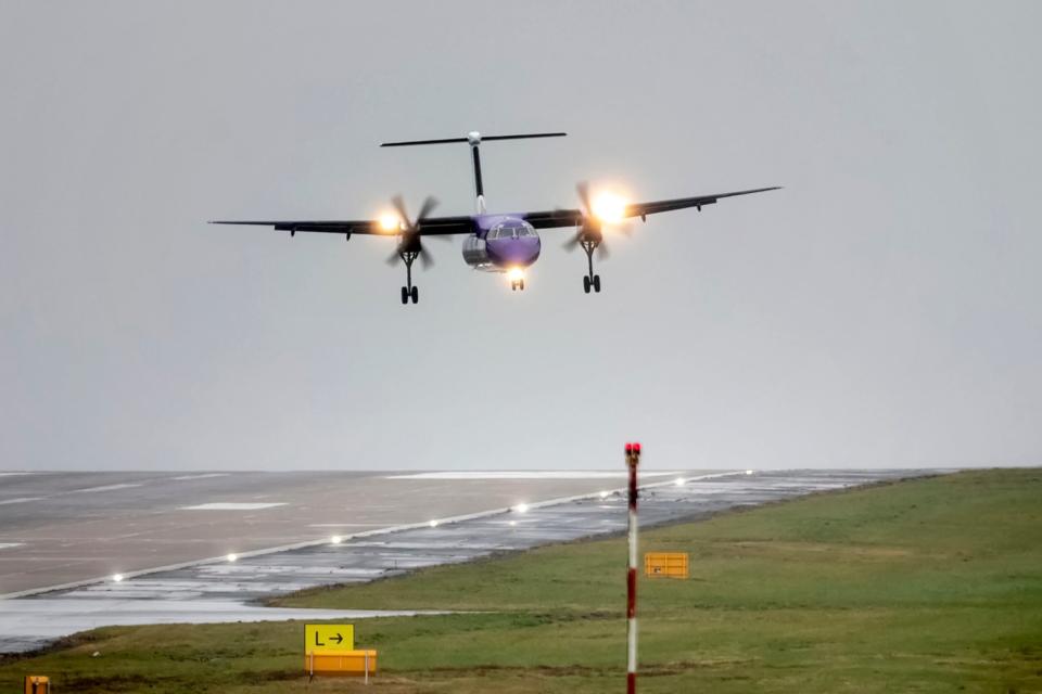 A plane lands in crosswinds at Leeds Bradford Airport in Yorkshire, as Storm Gareth hits (PA)