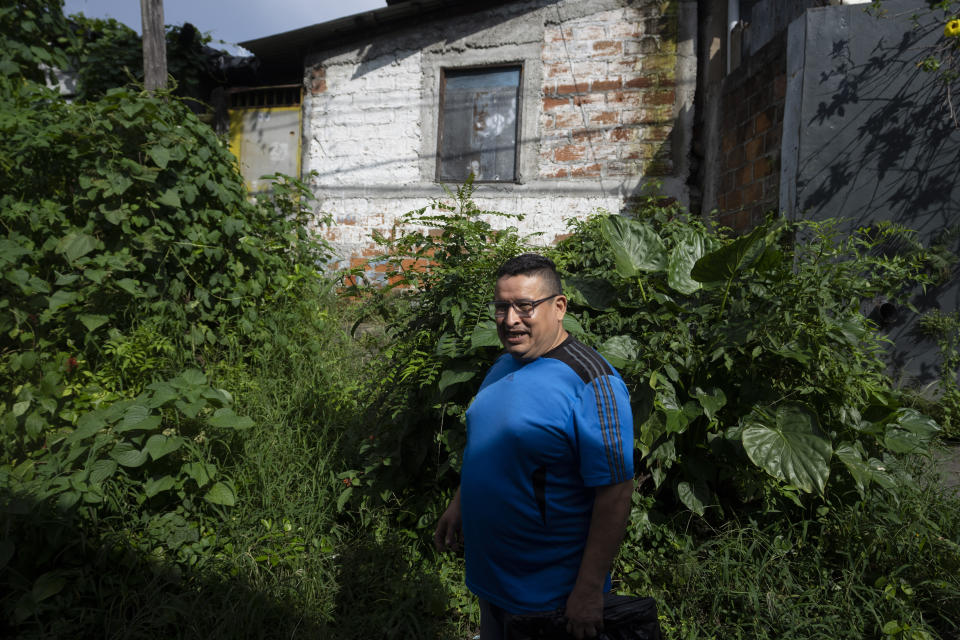 Jesus Joya stands outside the boardinghouse where his younger brother Henry was living when police removed him from the building and detained him under the "state of exception", in San Salvador, El Salvador, Wednesday, Oct. 12, 2022. The last time he saw Henry was in April when Henry was boarding a bus along with other prisoners outside a detention center to be transported to the Mariona prison. After losing track of Henry, he forced himself to go to the morgue in September where he learned that Henry had died in the Mariona prison on May 25, barely a month after his arrest. (AP Photo/Moises Castillo)