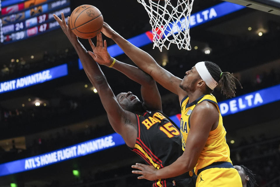 Atlanta Hawks center Clint Capela (15) is defended by Indiana Pacers center Myles Turner (33) as he goes up for a shot during the first half of an NBA basketball game Friday, Jan. 12, 2024, in Atlanta. (AP Photo/John Bazemore)