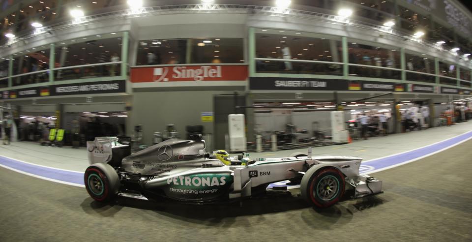 Mercedes Formula One driver Nico Rosberg of Germany drives in the pit lane during the qualifying session of the Singapore Formula One Grand Prix September 21, 2013. REUTERS/Pablo Sanchez (SINGAPORE - Tags: SPORT MOTORSPORT F1)