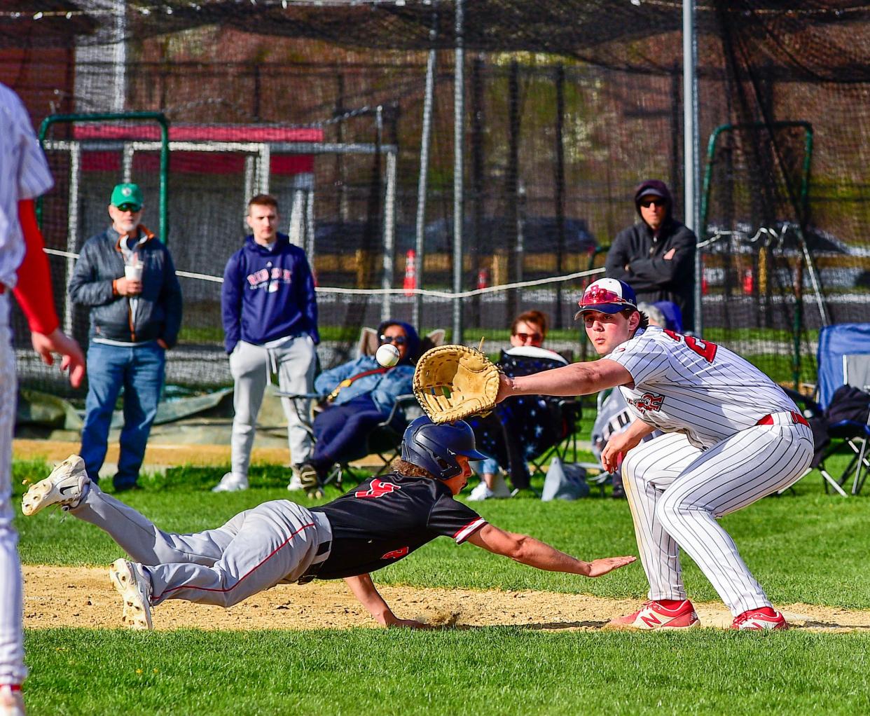 Bridgewater-Raynham’s Tyler Cattoggio takes the throw as Durfee’s Cayden Martins gets back to first during Wednesday’s game.