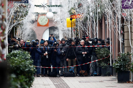 Journalists work in a street at the scene of a police operation the day after a shooting in Strasbourg, France, December 12, 2018. REUTERS/Christian Hartmann