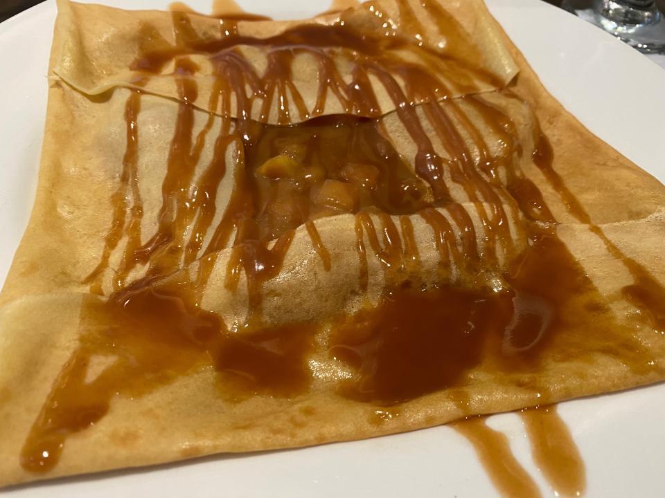 apple crepe with caramel on white plate at le creperie de paris at epcot