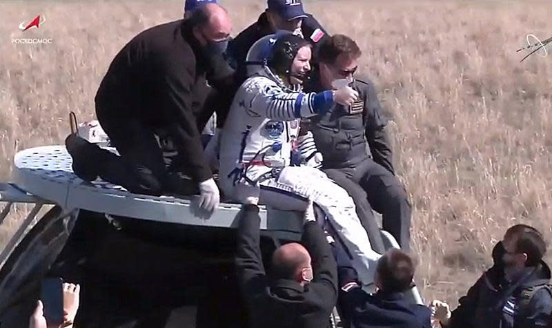 Astronaut Kate Rubins flashes a thumbs up to support crews after being helped from the cramped Soyuz crew module. All three crew members appeared healthy and in good spirits after a 50-minute descent from orbit. / Credit: NASA/Roscosmos