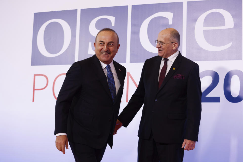 Polish Minister of Foreign Affairs Zbigniew Rau, right, welcomes his Turkish counterpart Mevlut Cavusoglu , left, during a high-level meeting of the Organization for Security and Cooperation in Europe in Lodz, Poland, Thursday, Dec. 1, 2022. The OSCE is Europe's largest security organization, one founded to maintain peace and stability on the continent. Russia's war against Ukraine is among the greatest challenges the body has faced in its nearly half century of existence. (AP Photo/Michal Dyjuk)