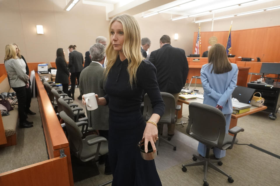 Gwyneth Paltrow exits the courtroom with a ceramic mug and metal cup after testifying in her trial, Friday, March 24, 2023, in Park City, Utah. Paltrow is accused in a lawsuit of crashing into a skier during a 2016 family ski vacation, leaving him with brain damage and four broken ribs. (AP Photo/Rick Bowmer, Pool)