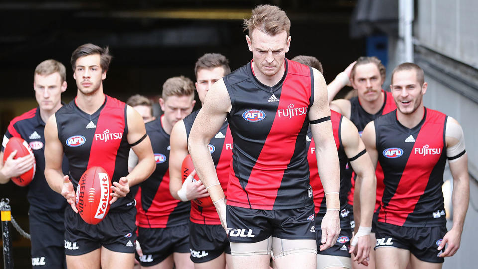 Brendon Goddard is seen here leading out Essendon during his time as club captain.