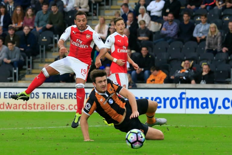 Arsenal's midfielder Santi Cazorla (L) has a shot on goal during the English Premier League football match between Hull City and Arsenal