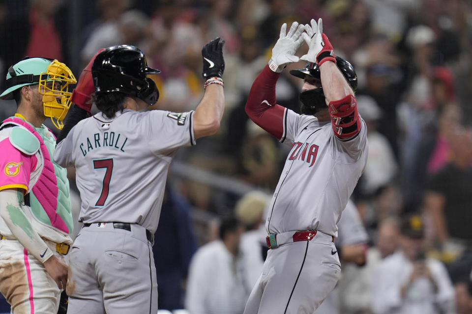 Arizona Diamondbacks' Randal Grichuk, right, celebrates with teammate Corbin Carroll (7) after hitting a two-run home run during the ninth inning of a baseball game against the San Diego Padres, Friday, July 5, 2024, in San Diego. (AP Photo/Gregory Bull)