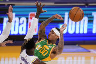 Utah Jazz guard Jordan Clarkson, right, passes the ball as Los Angeles Lakers guard Dennis Schroder defends during the first half of an NBA basketball game Saturday, April 17, 2021, in Los Angeles. (AP Photo/Mark J. Terrill)