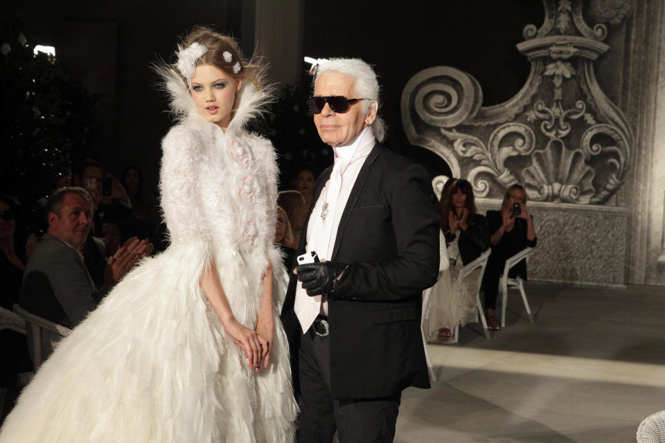 Model Lindsey Wixson and Lagerfeld walk the runway during the Chanel fall/winter 2012 couture show&nbsp;in Paris on July 3, 2012.&nbsp;