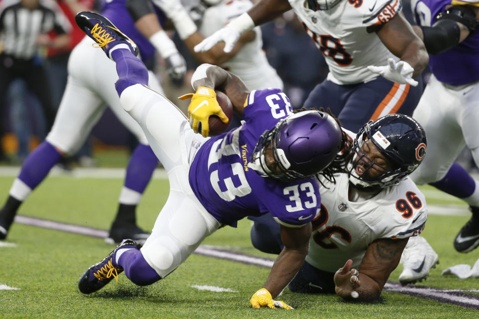 Minnesota Vikings running back Dalvin Cook (33) is tackled by Chicago Bears defensive end Akiem Hicks (96) during the first half of an NFL football game, Sunday, Dec. 30, 2018, in Minneapolis. (AP Photo/Bruce Kluckhohn)