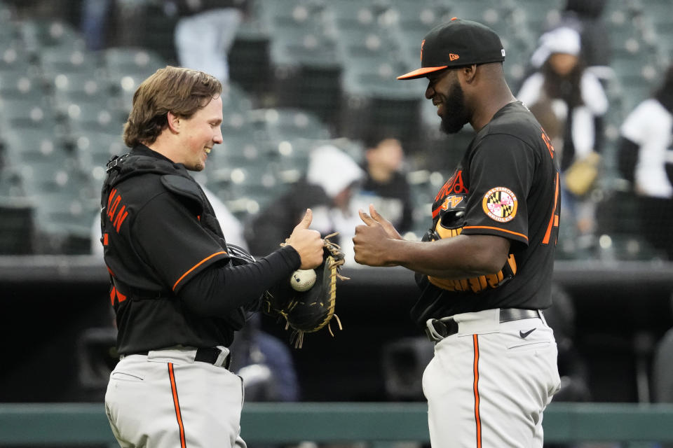 Baltimore Orioles catcher Adley Rutschman, left, celebrates with relief pitcher Felix Bautista after they defeated the Chicago White Sox in a baseball game in Chicago, Sunday, April 16, 2023. (AP Photo/Nam Y. Huh)