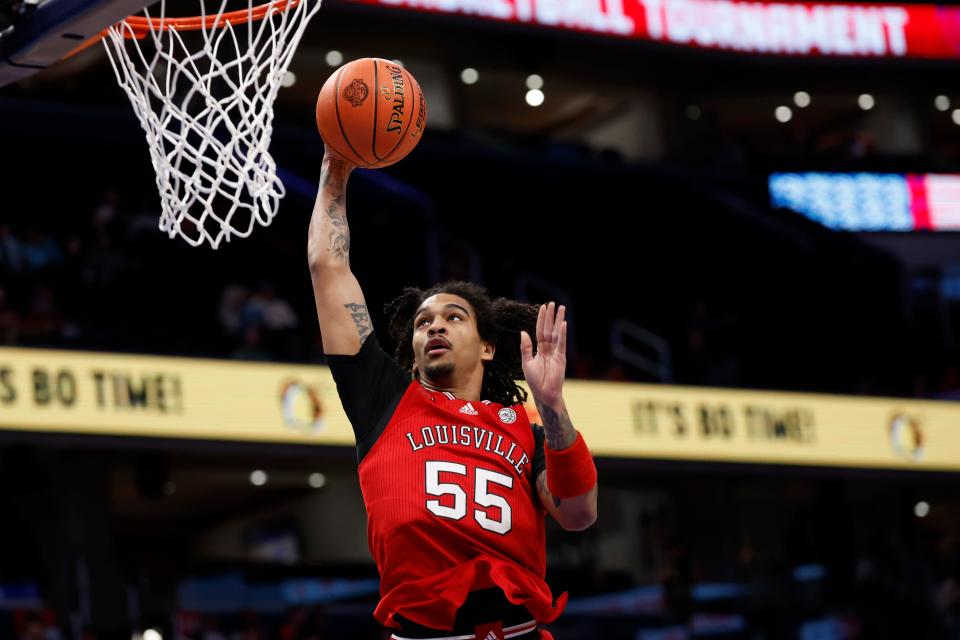 Louisville Cardinals guard Skyy Clark (55) dunks the ball against the North Carolina State Wolfpack in the first half Tuesday at Capital One Arena in Washington.