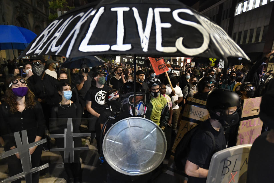 Demonstrators march through the streets in Rochester, N.Y., Friday, Sept. 4, 2020 protesting the death of Daniel Prude. Prude apparently stopped breathing as police in Rochester were restraining him in March 2020 and died when he was taken off life support a week later. (AP Photo/Adrian Kraus)