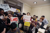 <p>People crowd the entrance to the office of Florida Gov. Rick Scott with boxes of petitions for gun control reform, after a rally on the steps of the state Capitol in Tallahassee, Fla., Wednesday, Feb. 21, 2018. (Photo: Gerald Herbert/AP) </p>