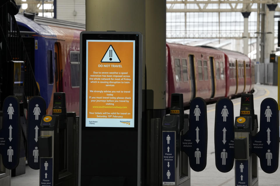 Signs showing cancellations across the board as commuters look at options as all trains from Waterloo Station are cancelled due to sever weather n London, Friday, Feb. 18, 2022. Millions of Britons are being urged to cancel travel plans and stay indoors Friday amid fears of high winds and flying debris as the second major storm this week prompted a rare "red" weather warning across southern England (AP Photo/Alastair Grant)