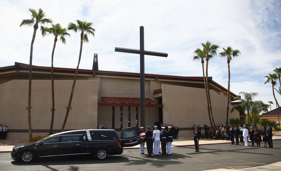 <p>A military team removes the casket carrying Sen. John McCain, R-Ariz., from the hearse prior to a memorial service at North Phoenix Baptist Church as McCain’s immediate family watches, right, Thursday, Aug. 30, 2018, in Phoenix. (Photo: Ross D. Franklin/AP) </p>