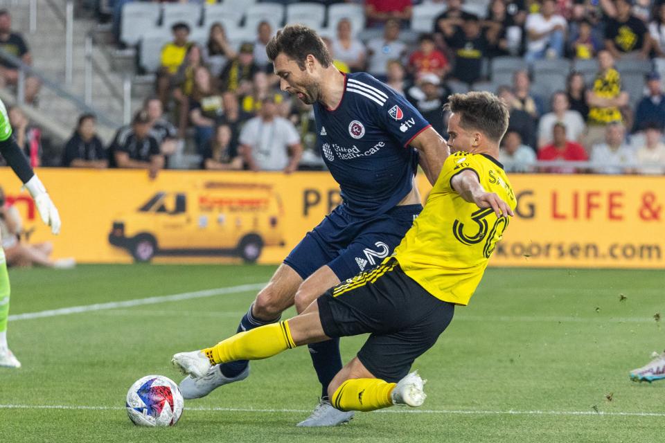 Apr 15, 2023; Columbus, Ohio, USA; Columbus Crew defender Will Sands (30) kicks the ball while New England Revolution defender Dave Romney (2) defends in the first half at Lower.com Field. Mandatory Credit: Trevor Ruszkowski-USA TODAY Sports