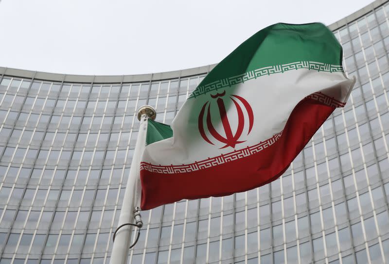 FILE PHOTO: An Iranian flag flutters in front of the IAEA headquarters in Vienna