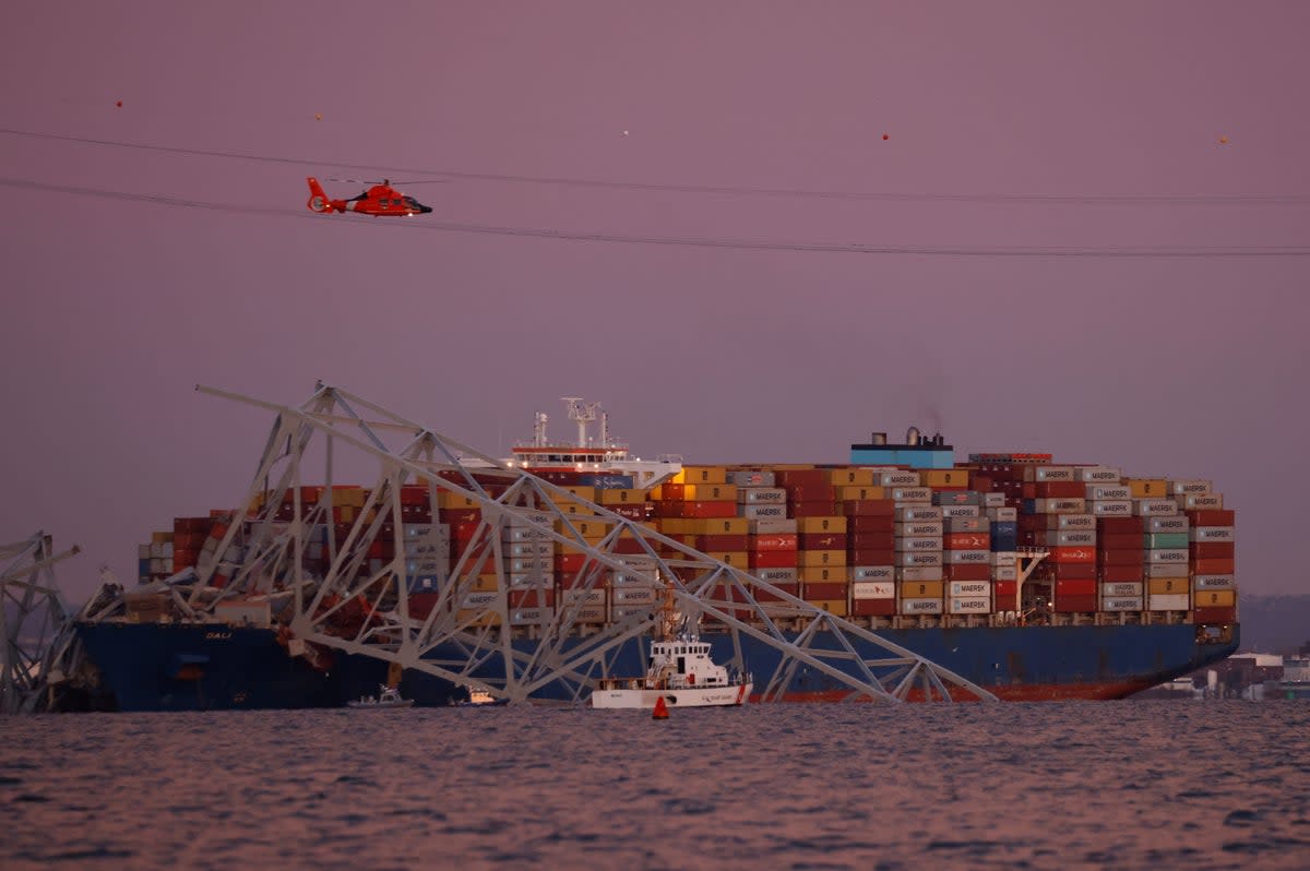 A helicopter flies over the scene of the Francis Scott Key Bridge collapse in Baltimore, Maryland (REUTERS)