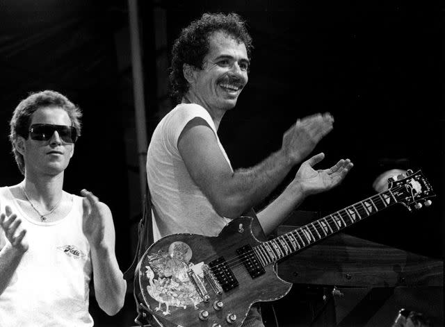 <p>Ebet Roberts/Getty</p> John McEnroe onstage with Carlos Santana in 1981