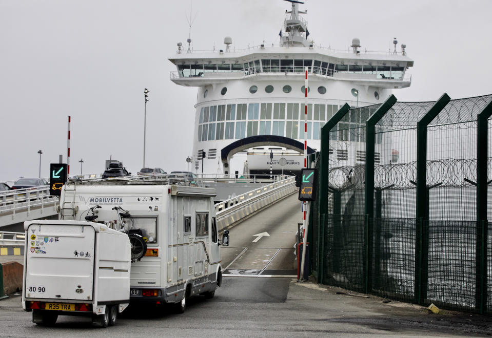 Cars are loaded onto a cross-channel ferry at the Port of Dunkerque, France, Friday Aug.14, 2020. British holiday makers in France were mulling whether to return home early Friday to avoid having to self-isolate for 14 days following the U.K. government's decision to reimpose quarantine restrictions on France amid a recent pick-up in coronavirus infections. (AP Photo/Olivier Matthys)