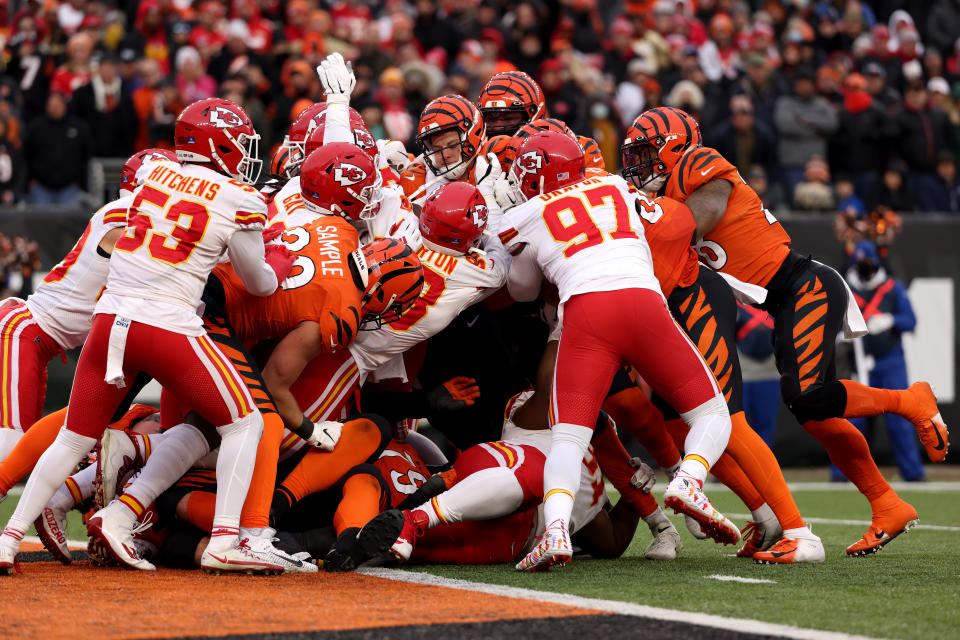 CINCINNATI, OHIO - JANUARY 02: Joe Burrow #9 of the Cincinnati Bengals is tackled by the defense of the Kansas City Chiefs in the fourth quarter of the game at Paul Brown Stadium on January 02, 2022 in Cincinnati, Ohio. (Photo by Dylan Buell/Getty Images)