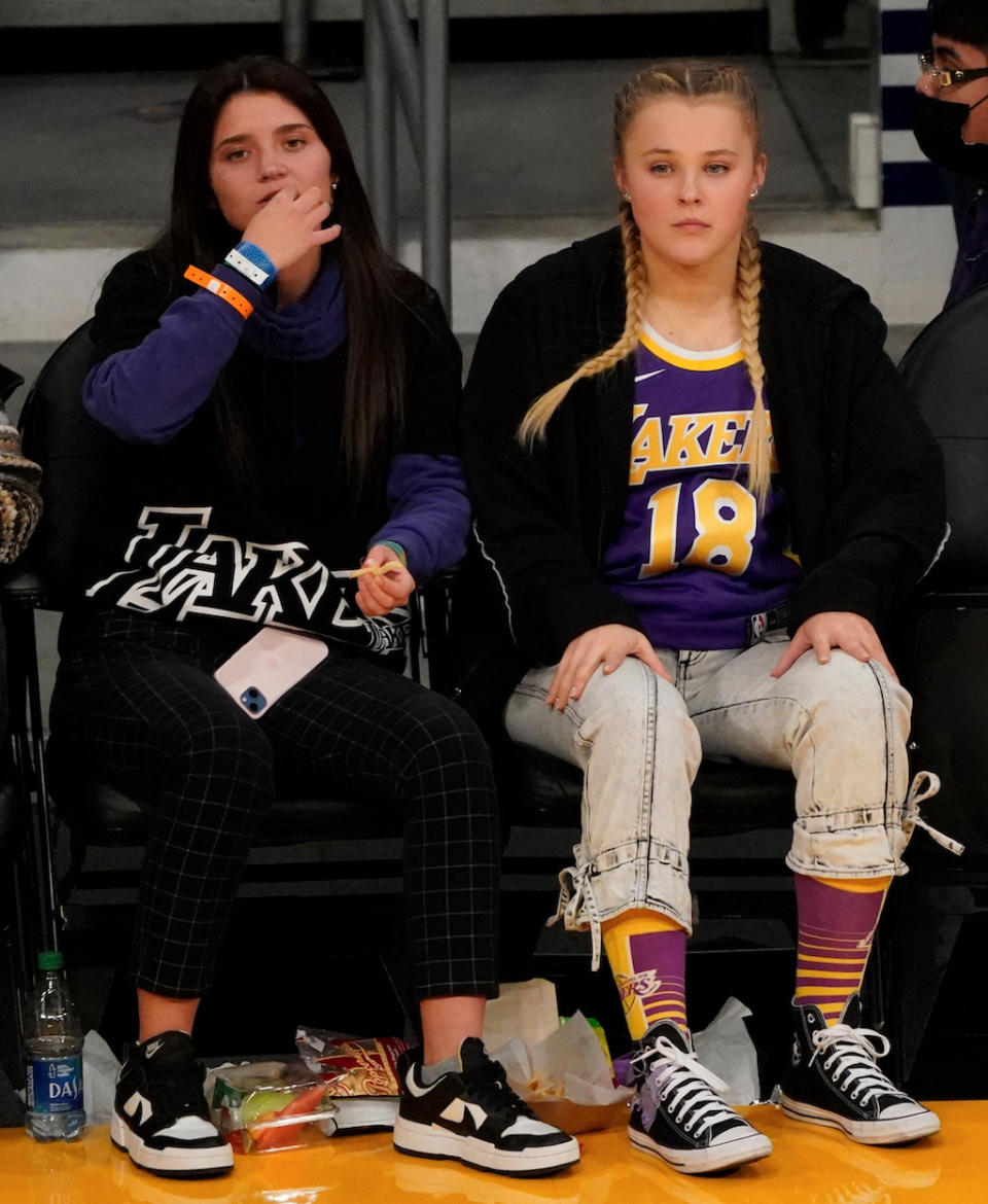 Jojo Siwa (R) and with Katie Mills spotted as the Phoenix Suns play the Los Angeles Lakers at Staples Center on Dec. 21, 2021 in Los Angeles. - Credit: London Entertainment / SplashNews.com