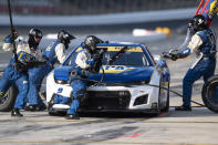 The pit crew of Chase Elliott (9) race to complete a pit stop during a NASCAR Cup Series auto race at Charlotte Motor Speedway, Sunday, Oct. 9, 2022, in Concord, N.C. (AP Photo/Matt Kelley)