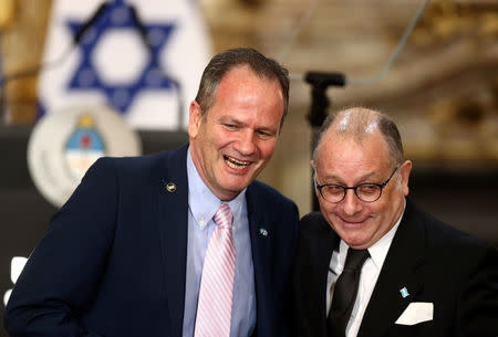 Argentina's Foreign Minister Jorge Faurie and Israel's Ambassador in Argentina Ilan Sztulman laugh after signing agreements during a ceremony as part of the visit by Israeli Prime Minister Benjamin Netanyahu at the Casa Rosada Presidential Palace in Buenos Aires, Argentina September 12, 2017. REUTERS/Marcos Brindicci