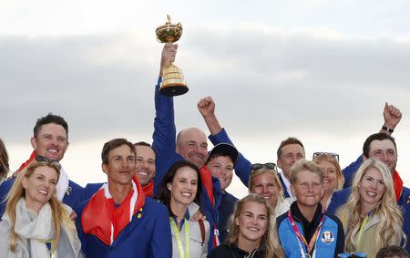 Golf - 2018 Ryder Cup at Le Golf National - Guyancourt, France - September 30, 2018 - Team Europe captain Thomas Bjorn holds the trophy as they celebrate after winning the Ryder cup REUTERS/Paul Childs