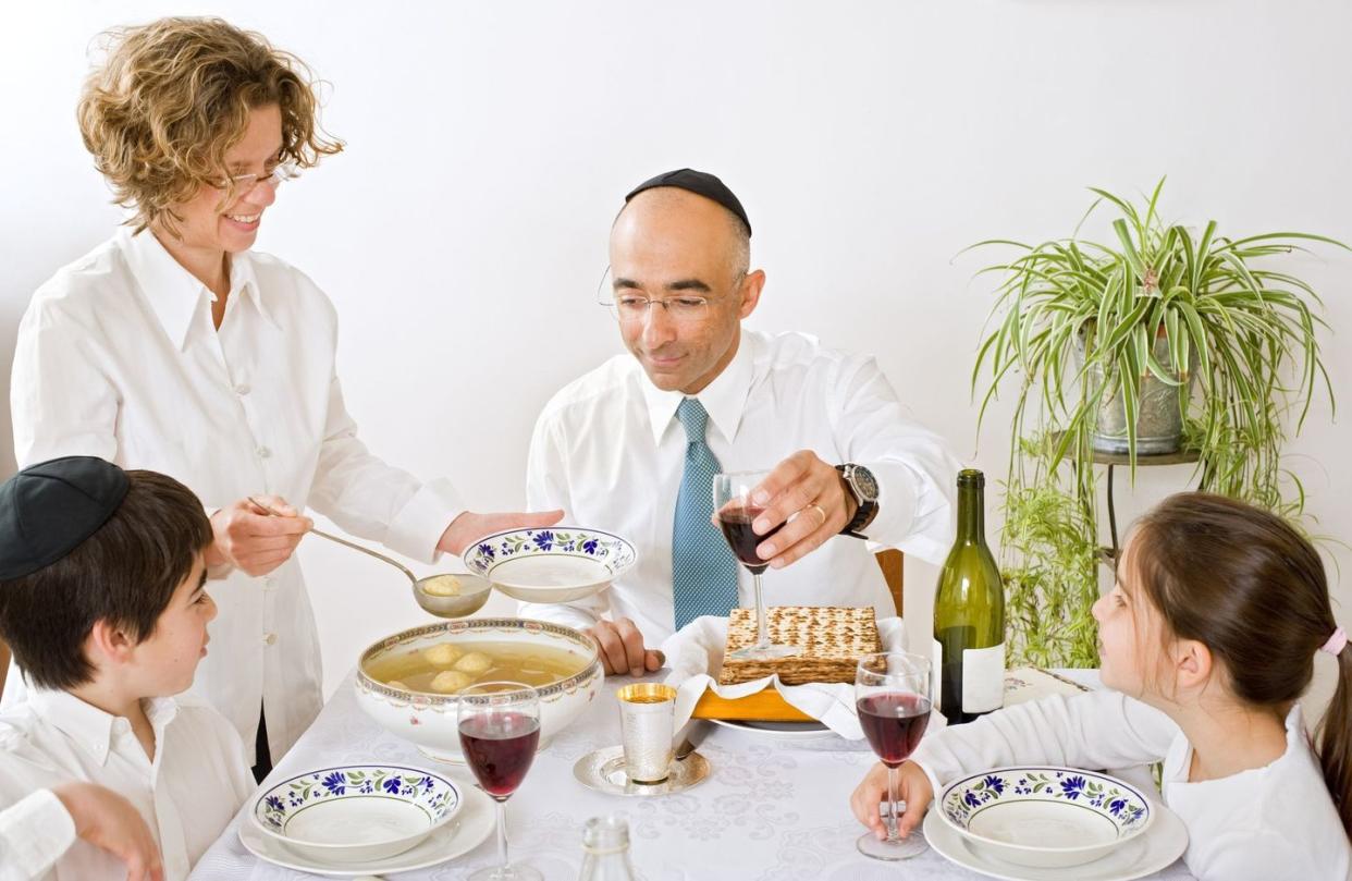 father mother son and daughter in seder celebrating passover