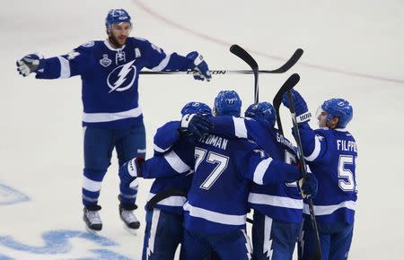 Jun 6, 2015; Tampa, FL, USA; Tampa Bay Lightning defenseman Jason Garrison (5) is congratulated by teammates after scoring a goal against the Chicago Blackhawks in the third period in game two of the 2015 Stanley Cup Final at Amalie Arena. Reinhold Matay-USA TODAY Sports