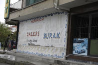 A Syrian car sellers with the original name changed from Arabic to Turkish after violent incidents in Altindag district in Ankara, Turkey, Wednesday, Sept. 15, 2021. Refugees fleeing the conflict in Syria once were welcomed in neighboring Turkey with open arms and compassion for fellow Muslims. But as their numbers swelled and Turkey became the host of one of the world's largest refugee populations in the world, attitudes gradually hardened. Anti-immigrant sentiment now is spilling over into open aggression and violence. (AP Photo/Burhan Ozbilici)