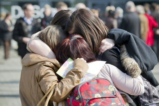 Girls comfort each other during a remembrance service for the victims of the March 13 bus crash in Switzerland on March 21, 2012 in Lommel, Belgium. Belgium's king and the Dutch crown prince joined thousands of mourners in a highly emotional homage Wednesday to the victims of last week's fatal school bus crash in a Swiss alpine tunnel