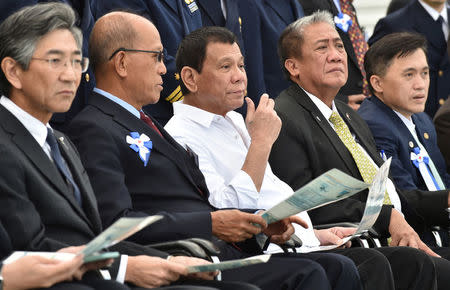 Philippine President Rodrigo Duterte (C), accompanied by Transportation Secretary Arthur Tugade (2nd R) and Defense Secretary Delfin N Lorenzana (2nd L), watches Japan's coast guard drills in Yokohama, Japan October 27, 2016. REUTERS/Kazuhiro Nogi/Pool