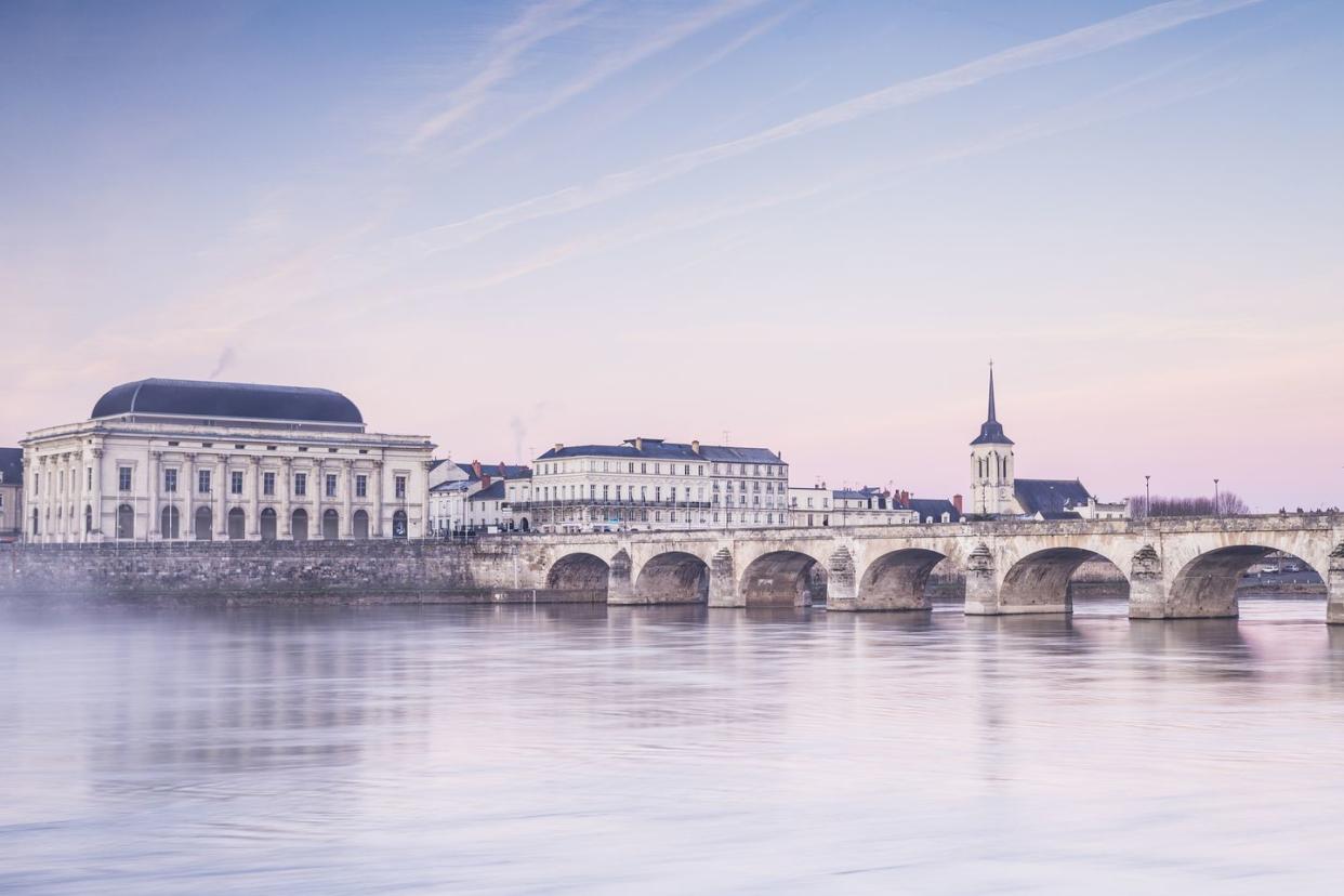 dawn over the river loire in the city of saumur, france